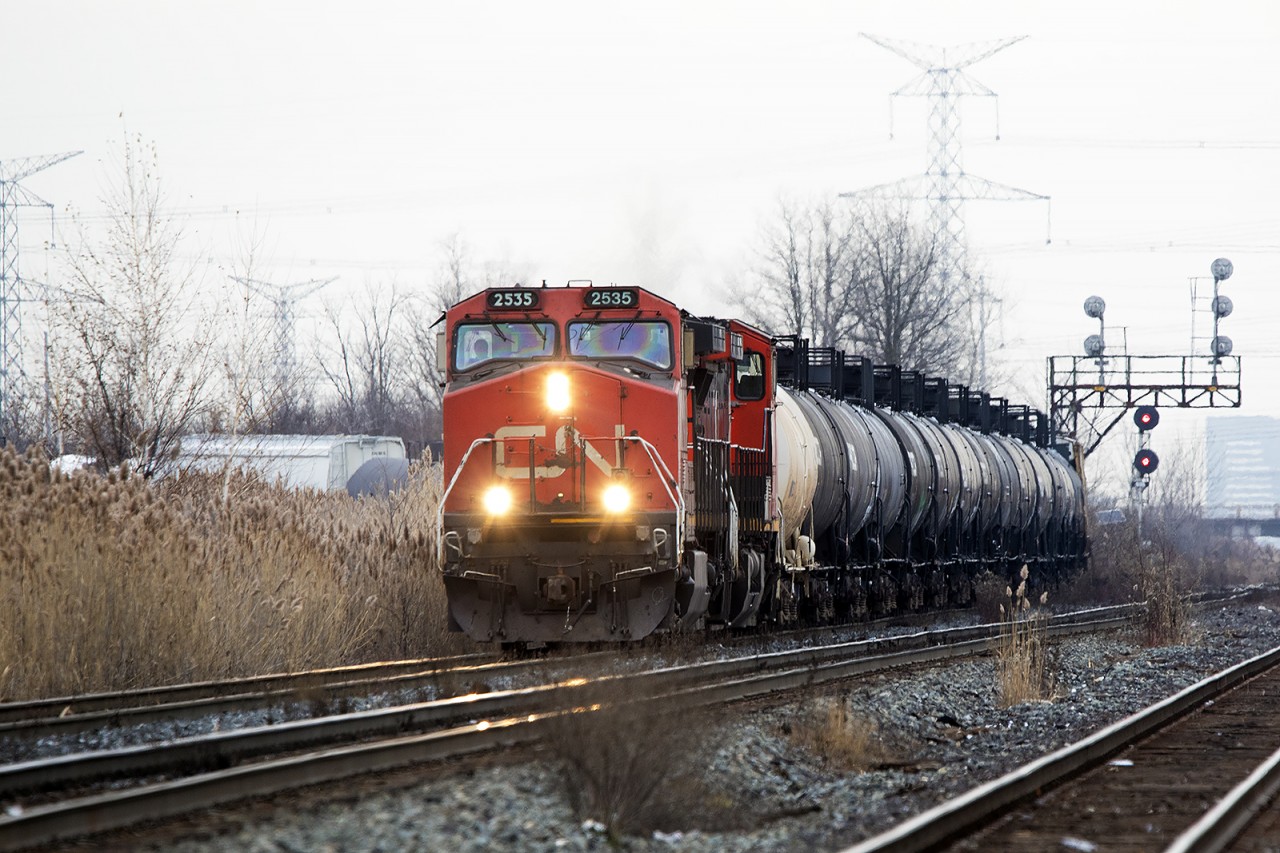 The fence posts are in and this scene at the Jane St crew change spot may already no longer be possible, 2535 and 2642 come wandering out onto the Halton Sub headed west. S