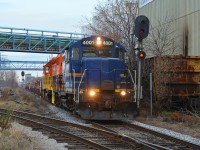 SOR crosses the diamonds of industrial Hamilton on the old N&NW with a head end cut of BNSF well cars and BRNX 2 bay hoppers from National Steel Car
