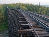 This bridge is still part of CN's (former NAR) Grande Prairie Subdivision but with rails removed and crossing's paved over on both sides of it, the chances of ever seeing another train on it are pretty slim. 