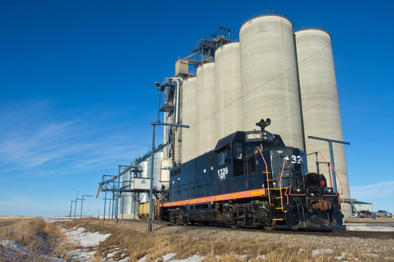 PWTX 1326 with it's Topeka cab and prevalent horn arrangement sit's plugged in at an elevator between Dodsland and Plenty Saskatchewan. The track to the left is CP's Kerrobert Sub.