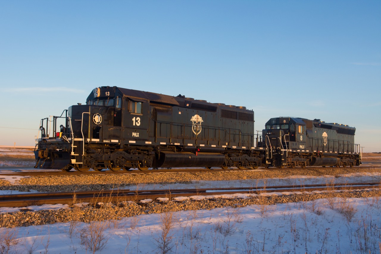 A pair of modern day "critters" soak in the last light of the day. This P&H facility is located along CN's Wainwright Subdivision with CP's Wilkie Sub visible across the highway in the background. With the endless parade of GE's on both railways sometimes monotonous, it's nice to find little windows into the past like these two. #13 began life as CN 5063 while #8 started out as SP 8894