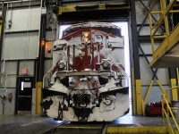 CP ES44AC 8705 backs out of the shop after completing a move pushing in a unit due for inspection wearing a coating of snow. 