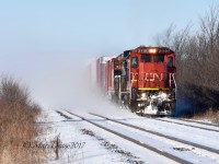 Train 394 with CN 2110 and CN 2162 stirs up last nights snow fall on its way out of Sarnia.