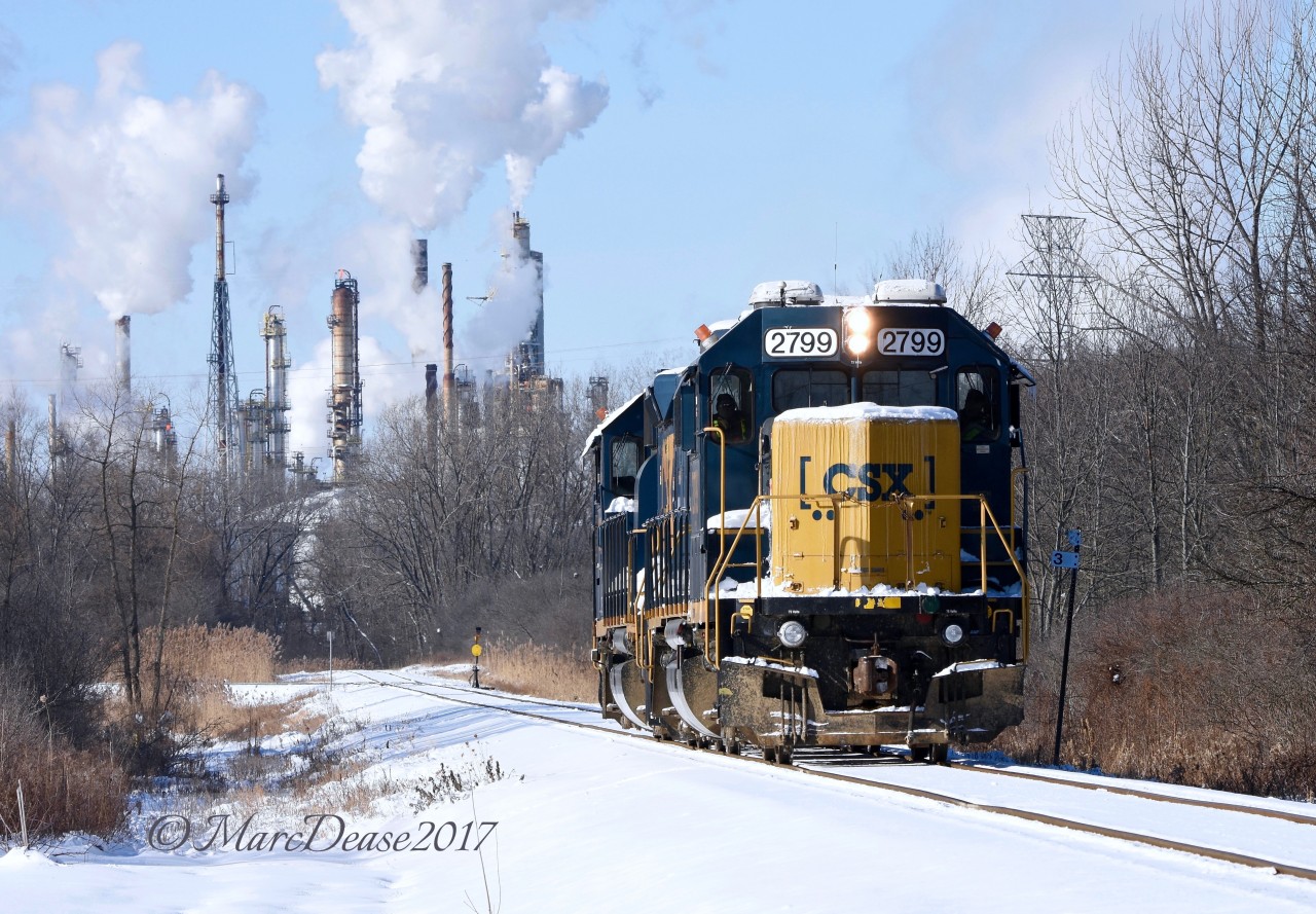 The daily CSX Industrial on its way to the CN Yard light power with a nice layer of fresh snow and the steam plumes from Suncor's Sarnia Refinery.