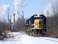 The daily CSX Industrial on its way to the CN Yard light power with a nice layer of fresh snow and the steam plumes from Suncor's Sarnia Refinery.