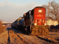 CN 5724 leads a short 12 car 438 out of Windsor on a crisp November morning, back when both lines were in use. The train will crossover to the former eastbound main and head southeast to Essex and Fargo on the CASO, just months before abandonment. 