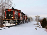 CN 438 lead by CN GMD1 1412, CN 6020 and CN 7058 lead a short freight just North of Essex over the CASO. The three locomotives and blowing snow give the impression of a much larger train, but back then as today, trains 438/439 didn't usually run on Sundays, so seeing this 9-car freight this day with this power was rather exciting. Caught it on my way to the Essex train show, only 78 days before total abandonment. 