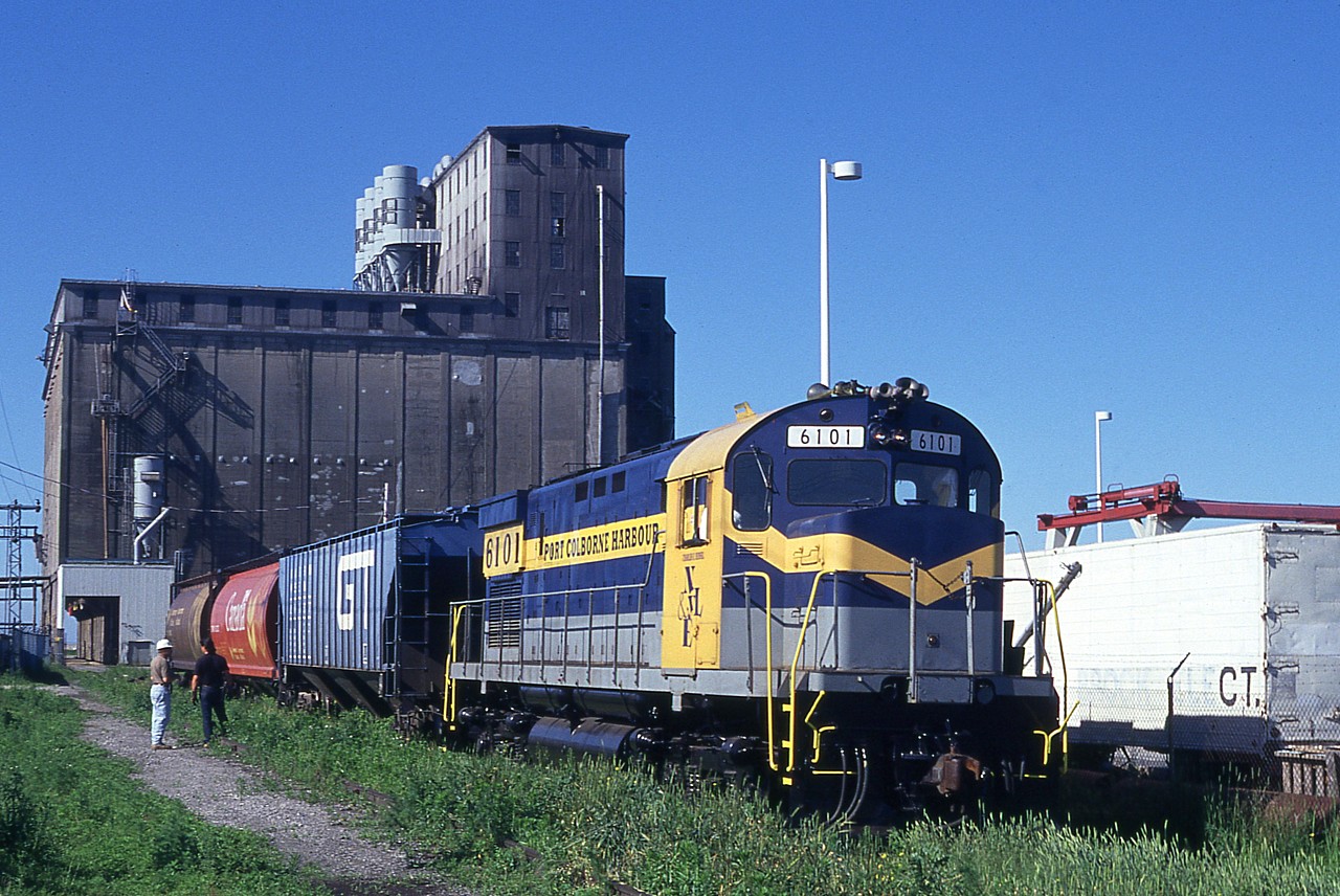 Trillium Rwy was still known as the Port Colborne Harbour Railway when this image was shot. PCHR 6101, a C425, is seen servicing the Goderich Elevator down at the Lake Erie shores on a beautiful July morning. This is the first month of the railroad's operation. The 6101 has had a long history, from being built 1965 it was shop switcher at Morrison-Knudsen in Hornell, NY until the late 1980s; went to New York & Lake Erie for a spell, then restencilled PCHR for the startup of the PCHR July 1997; toiled until 2001 when it went back to the NYLE and then shipped off to the Delaware-Lackawanna in Scranton, PA.  The unit is shown in NYLE colours.