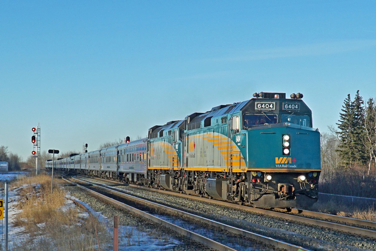 Running approximately 15 hours late VIA's eastbound "Canadian" catches the late afternoon sun as it rushes through Ardrossan.