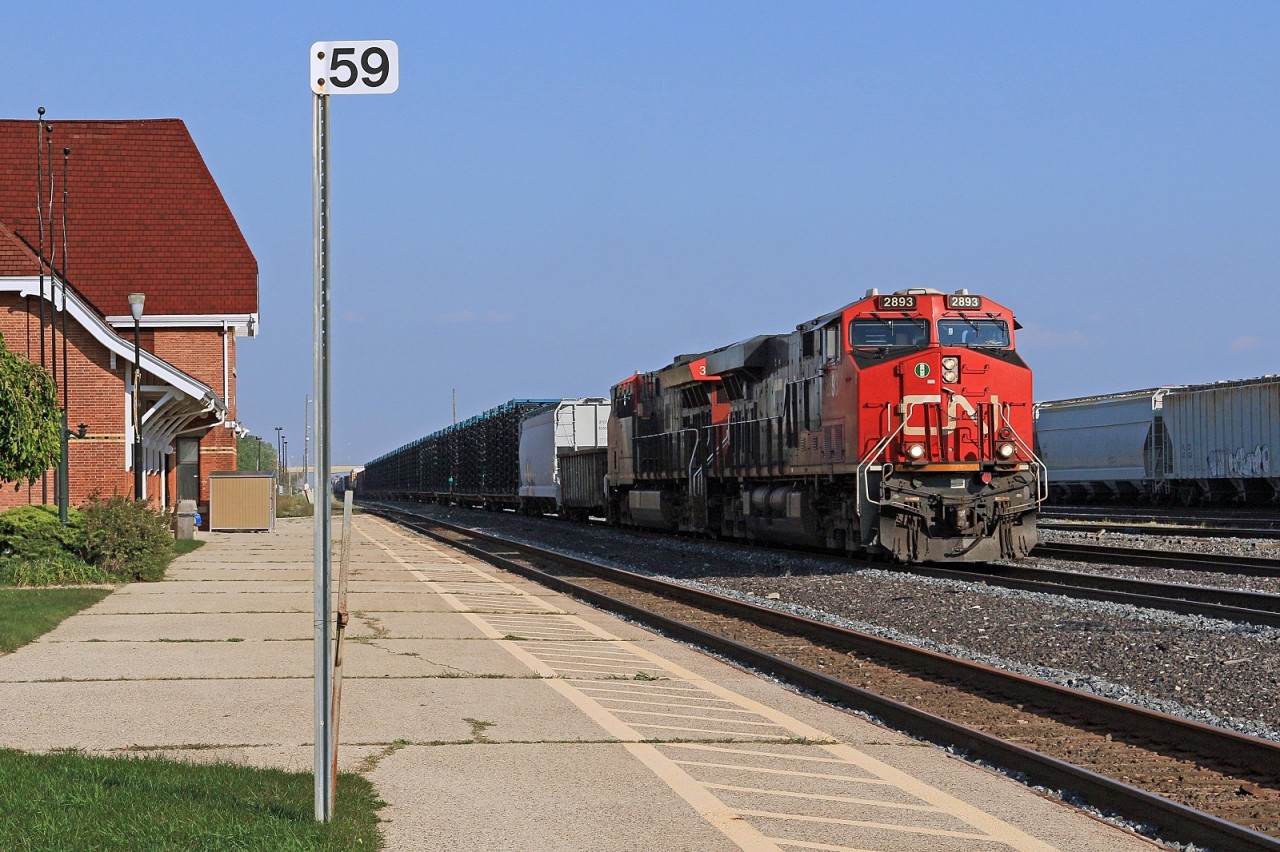 U.S. bound CN 2893, with helper 3032, ease their train past VIA's Sarnia station at mile 59 on the CN's Strathroy Sub.