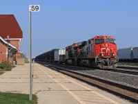 U.S. bound CN 2893, with helper 3032, ease their train past VIA's Sarnia station at mile 59 on the CN's Strathroy Sub.