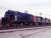Prior to the launch of service in May 1967, GO Transit's GP40TC units were used by CN in freight service around southern Ontario. Here we see "CN" 607, with RS18s 3739 and 3673 leading a westbound freight off the Halton sub onto the Oakville sub.