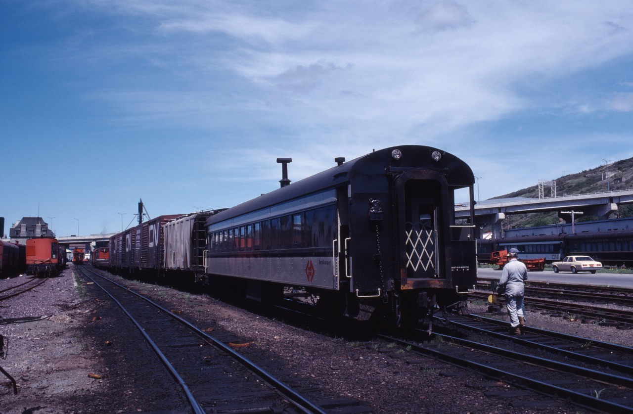 Mile 0 of the Newfoundland Railway. "Terra Transport" train 232 arrives in St. John's, one of four mixed trains still operating in the province in the summer of 1980. This train left for Argentia as No. 207 on Mondays, Wednesdays and Fridays, returning as far as Whitbourne as No. 208. After an overnight pause, No. 232 left Whitbourne on Tuesdays, Thursdays and Saturdays for the remainder of the trip. Units 800 and 805 were the power.
