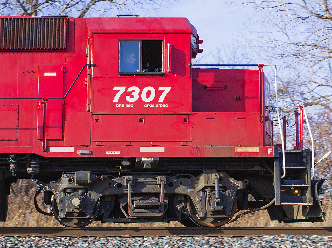 When taking this photo of CP work train T29, I didn't realize at first the significance of what was leading until I got home and browsed the photos I took. After all todays train was short with only one engine and three cars. Unfortunately, due to the mid-afternoon sun of the late fall season, most of my shots were backlit. Except this one. Fortunately for me, this is ex-Delaware & Hudson 7307, now sporting it's CP red. In the mist of my discovery, the engineer sure looks relaxed! :)