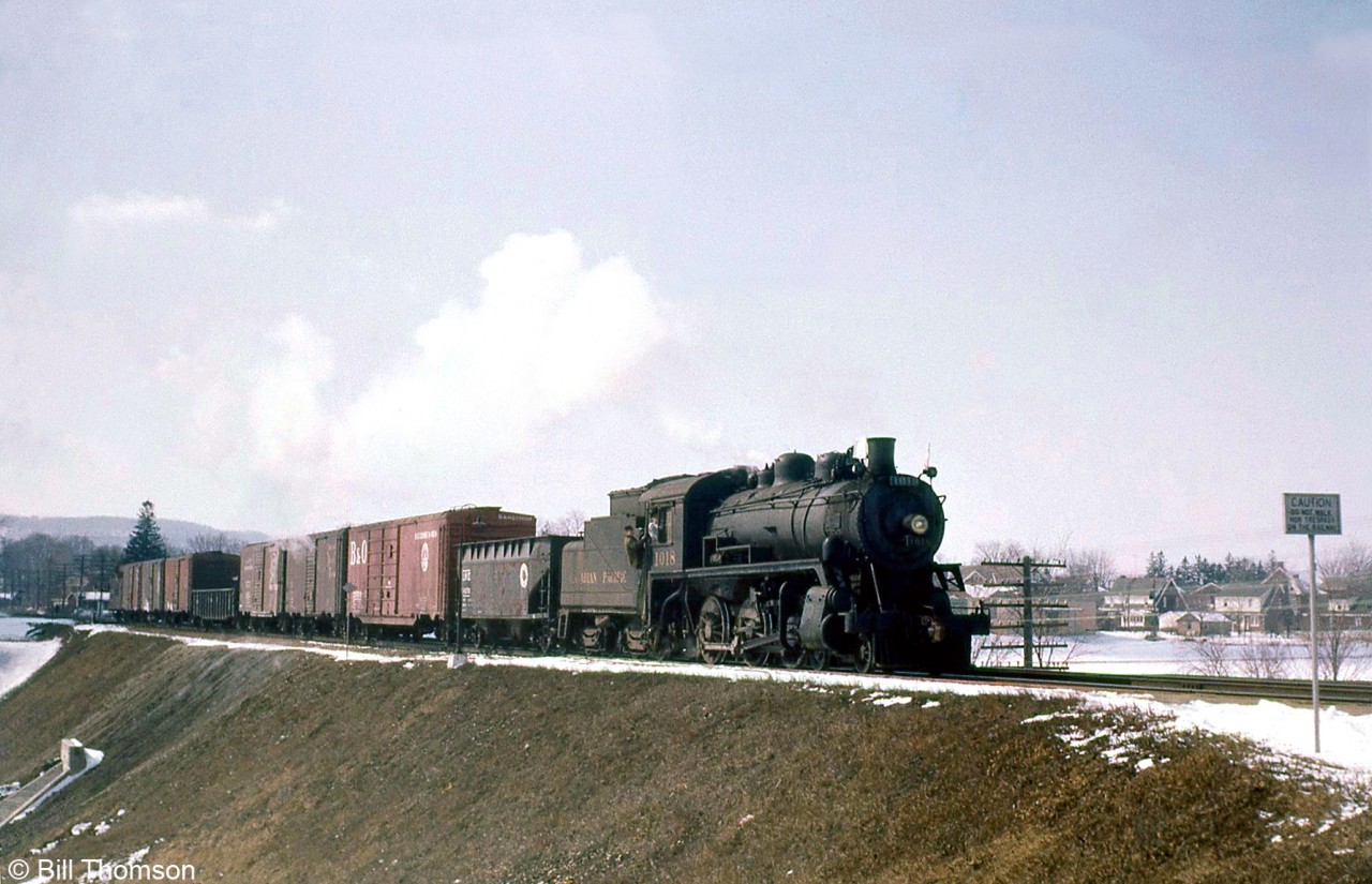 Canadian Pacific "Ten Wheeler" 1018 (a D10h class 4-6-0 built by MLW in 1912) handles the Stone Train eastbound at Milton in 1959. The D10's were versatile steam engines and were often found working branchline, local and road switcher work on CP.