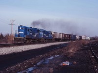 With the steel train rounding the wye off the TH&B, Conrail local is charging eastbound out of Waterford with a pair of Canadian geeps for motive power. (Corrections welcome please).