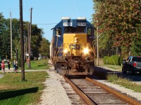  A group of children stand watching CSX 2574 shove 12 hoppers through Port Lambton as they sip on their slushies, not knowing they are watching history as this would be the last train to ride these rails since ownership of the line south of here was handed over to the Municipality of Chatham-Kent the next day. There was a BBQ/ pool party happening across the street from here and as I was setting up my camera someone on the patio hollered over at me asking if there was a train coming by, I told them there was and it would be the final train along here for a while, when the train came everyone at the party came out to watch it. 