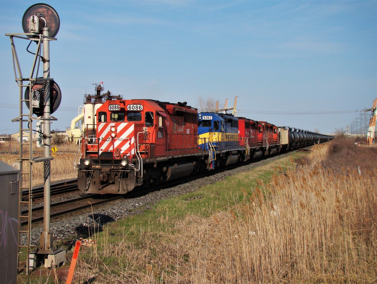 An all DME latchup has this empty tank train well in hand as they head past MP 105.9 on the CP Windsor sub.