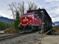 CP 9727 is crossing the Eagle River at mile 40.2 of the Shuswap sub and is in charge of an eastbound load of grain empties.