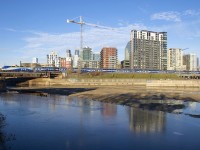 AMT 1364 leads a deadhead move towards the maintenance centre in Pointe St-Charles as it passes the mostly empty Peel Basin.