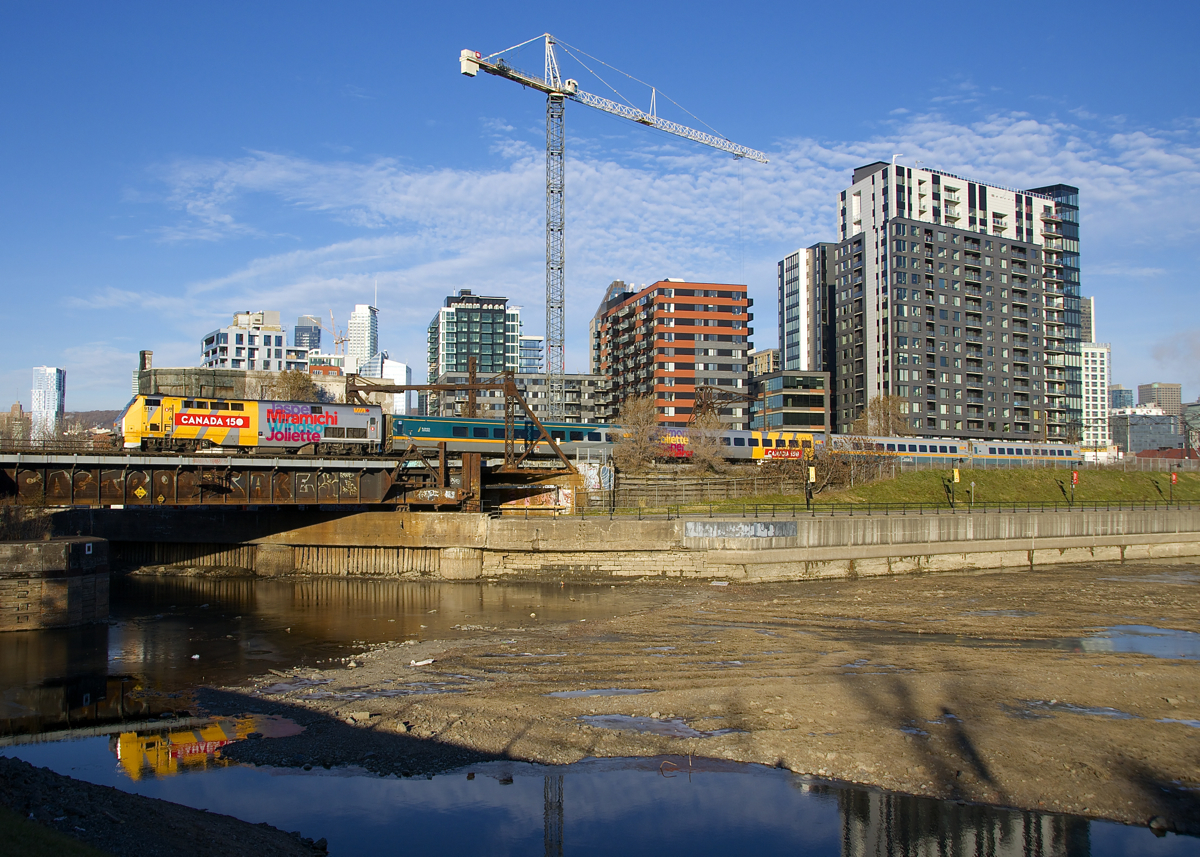 Up until a recent timetable change VIA 63 has always been composed of all or nearly all stainless steel cars, but it now sometimes sports a consist of four LRC cars, as shown here, with VIA 914 leading the train past Wellington Tower in Montreal.