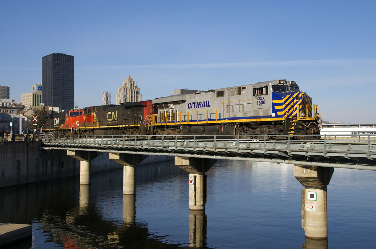 CN 878's light power is leaving the Port of Montreal with CREX 1506 leading IC 2698 and CN 2260 as they cross the canal after leaving most of their train in the port (some of it had been dropped off on track 29 at Turcot West before). CN has found itself power short and has leased approximately 25 CREX ES44AC's, as well, PRLX units (ex-BNSF SD75M's) and GECX units (ex-CSXT Dash8-40CW's) are also already on the property.