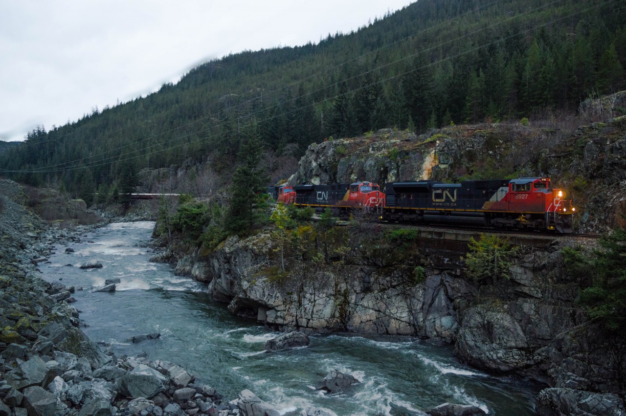 A northbound on CN's former BCR mainline grinds northward, fighting against gravity as the Cheakamus River roars in the opposite direction.