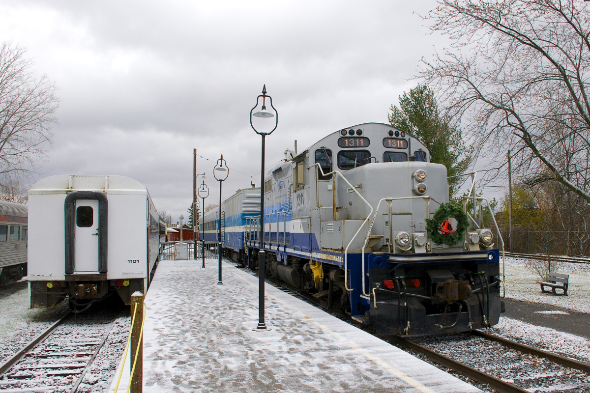 Exporail's Christmas Train (with a rare all-AMT consist of GP9 AMT 1311, generator car AMT 603 and coach AMT 827) approaches Hays Station to pick up another round of passengers. At left is coach AMT 1101.