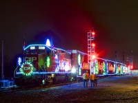 The U.S. version of CP's Holiday train is stopped beside the small yard at Delson as it makes its third stop of the night, with the head end stopped beside a new set of signals on CP's Adirondack Sub.