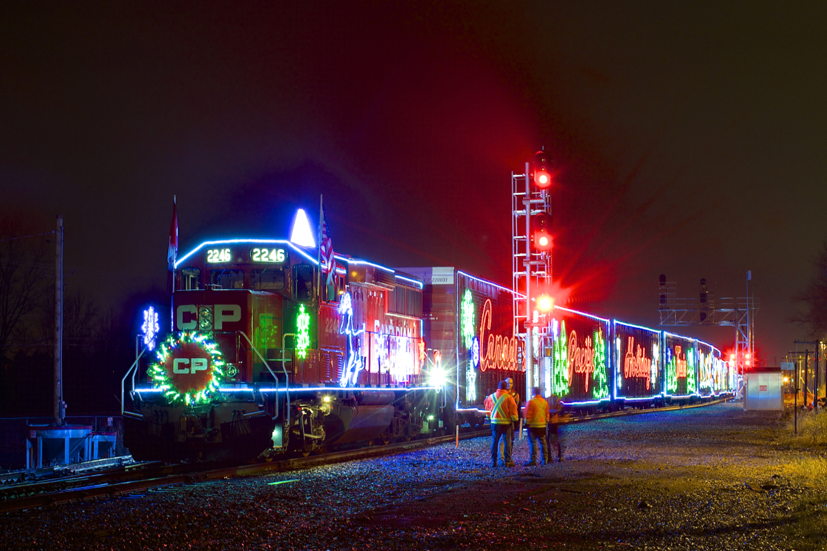 The U.S. version of CP's Holiday train is stopped beside the small yard at Delson as it makes its third stop of the night, with the head end stopped beside a new set of signals on CP's Adirondack Sub.