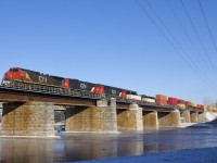 IC 2698 leads a pair of ex-Oakway SD60's (CN 5415 & CN 5451) over the Ottawa River as CN 149 leaves the island of Montreal. It is a very cold morning, as evidenced by steam coming off the river.