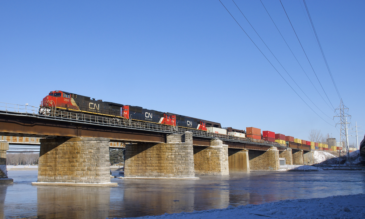 IC 2698 leads a pair of ex-Oakway SD60's (CN 5415 & CN 5451) over the Ottawa River as CN 149 leaves the island of Montreal. It is a very cold morning, as evidenced by steam coming off the river.