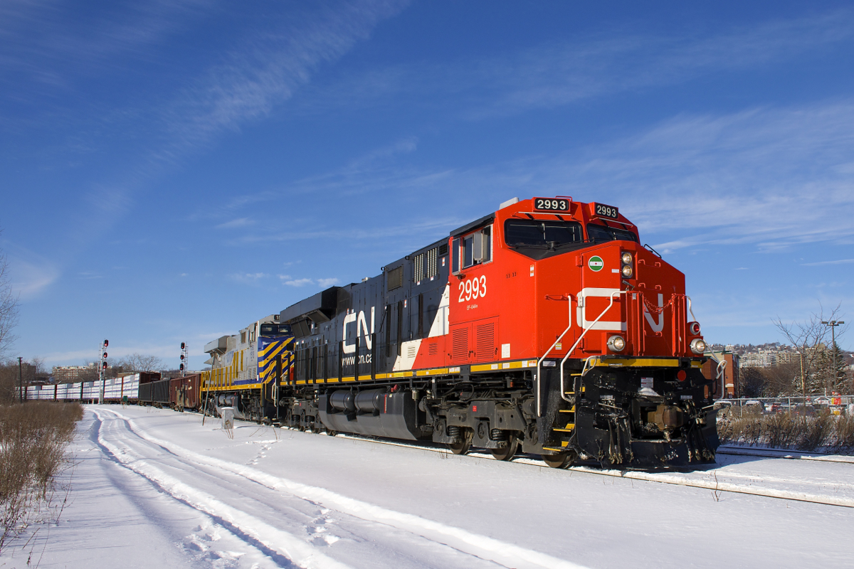 CN 310 is rounding a curve in the St-Henri neighbourhood of Montreal with two good looking ES44AC's for power on a sunny Christmas Eve morning. Leading is nearly brand new CN 2993 and trailing is leased unit CREX 1518. A few minutes later CN 120 (which is the train I was expecting to shoot) would pass on the north track.