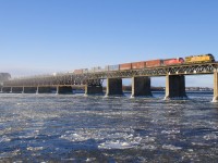 Normally running into Montreal in the middle of the night for over a year now, CP 253 is seen making a rare daylight run into Montreal on a frigid and windy morning as UP 5332 and CP 5047 lead the train over the icy St. Lawrence river.