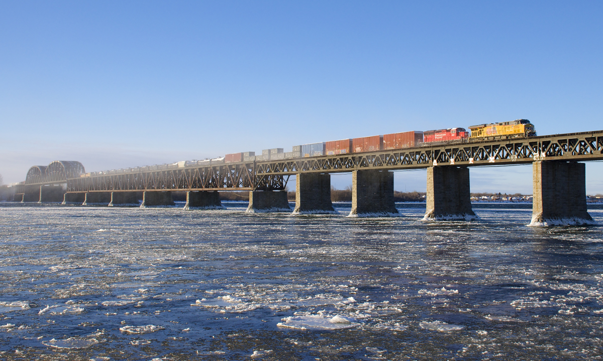 Normally running into Montreal in the middle of the night for over a year now, CP 253 is seen making a rare daylight run into Montreal on a frigid and windy morning as UP 5332 and CP 5047 lead the train over the icy St. Lawrence river.