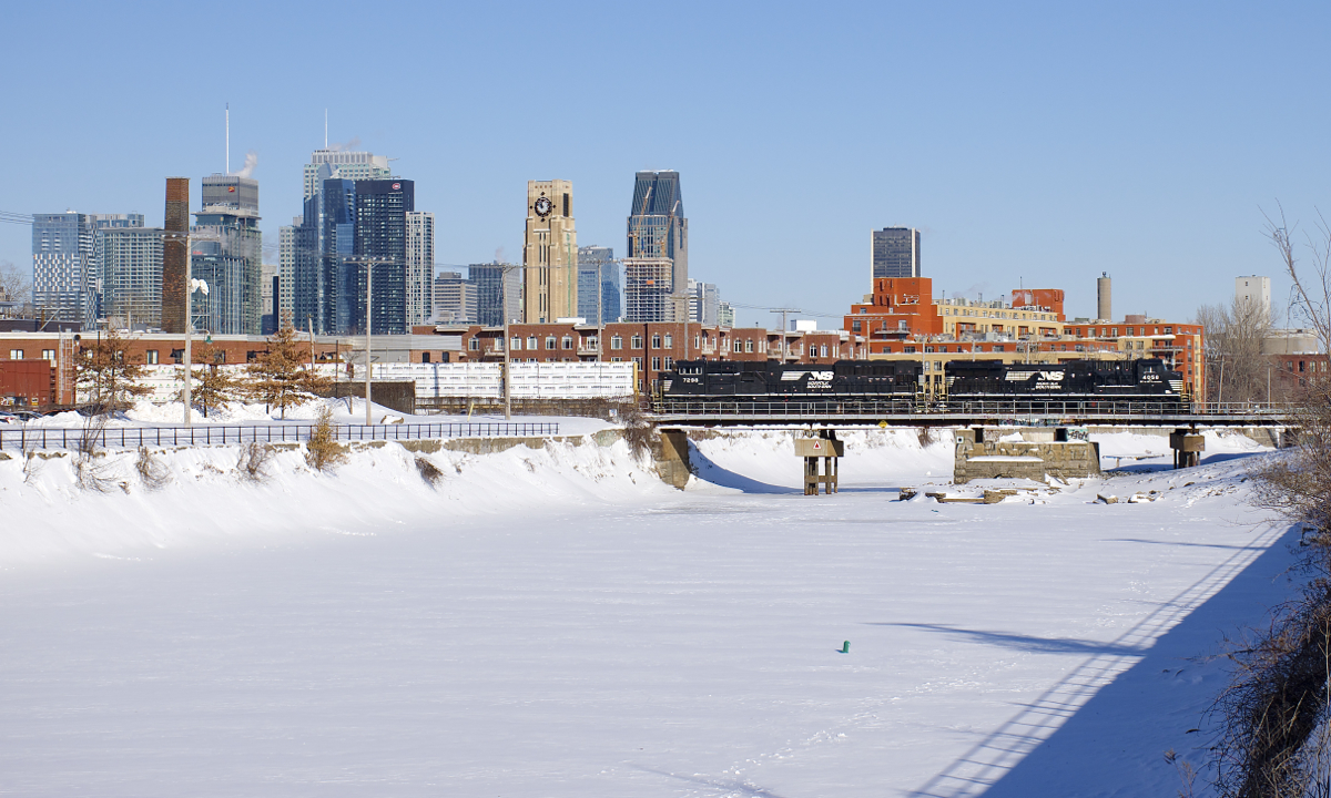 CN 528 is crossing the Lachine Canal with the skyline of downtown Montreal in the background on a truly frigid day. Power is two recently rebuilt units: NS 4058 and NS 7298. NS 4058 is an AC44C6M that was originally C40-9 NS 8800. NS 7298 was built as an SD9043MAC for Union Pacific in 1996 as UP 8070, later being renumbered to UP 3532. Norfolk Southern bought it from UP in 2014 and rebuilt it to an SD70ACu in 2016.