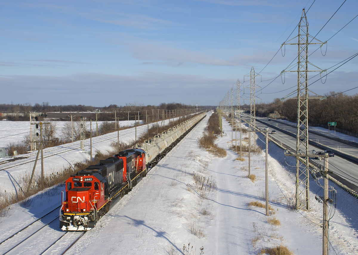 With the windchill showing a temperature of -36 Celsius (-32.8 Fahrenheit), somehow I'm on an overpass in Sainte-Anne-de-Bellevue to shoot CN 585 with two older EMD's for power (CN 5442 and CN 9411) and a solid TankTrain consist, destined for Maitland, Ontario.