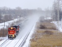 Most of CN 377's train is rendered invisible by the snow it's kicking up as it heads west through Pointe-Claire with CN 2114 & CN 2512 for power.