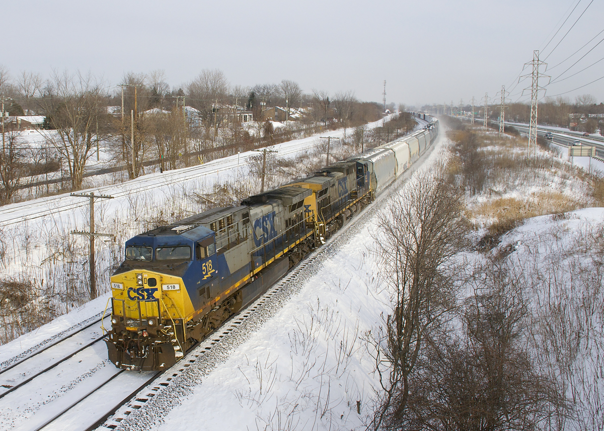 A pair of CSXT AC4400CW's still in the endangered YN2 paint scheme (CSXT 518 & CSXT 143) lead CN 327 around a curve in Beaconsfield on yet another frigid day.