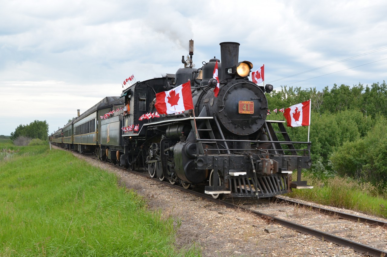 Celebrating Canada's Sesquicentennial Canada Day ... trackside and part of the Rails & Tales Canada150 Steam Excursion / Program put on by the Alberta Prairie Railway. Canada Day 2017 started off at 7:00 a.m. sharp with a double header steam excursion (APST 41 & ARM 1392) from Stettler to Big Valley and return (12:00). Guests were treated to champagne and orange juice on the train enroute and a full buffet style pancake breakfast upon arrival in Big Valley. Both steamers were decked out in flags and colours to celebrate this special day and year. APST 41, with flags a flying and under full steam, was the sole motive power for Canada Day Special #2 excursion (3:15) to Big Valley. No. 41 is a 1920 Baldwin Consolidation 2-8-0 62 feet in length and weighing 244,000 pounds. The balance of the afternoon was spent at Big Valley enjoying the interesting historic displays, exhibits (yes even 'G' scale model train locomotives) and, of course, the impressive train station/museum. The day/evening was capped off with a barbequed steak and a cool 'Canadian'. Patriotic and  memorial experience or what! Now bring on 2018!