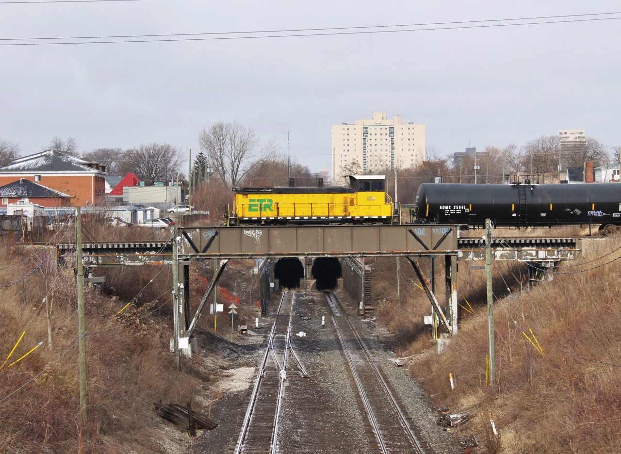 A w/b ETR local heads out to Ojibway Yard to do their work for the afternoon in the industrial area in Ojibway. Here they are crossing the CASO Sub and entrance to the Detroit River Rail Tunnel which is still used by CP.