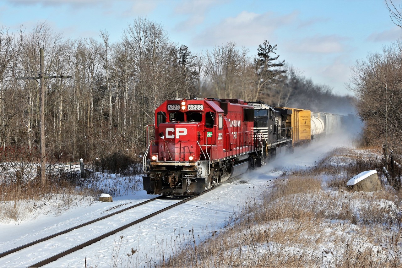 Damn it was cold, (-15C according to the detector), and windy but when you hear an SD60 leader get a clearance, you just have to wander down to the tracks and see what's up. Here, CP 6223 with NS 9058 head through Puslinch with their clearance to Ayr.