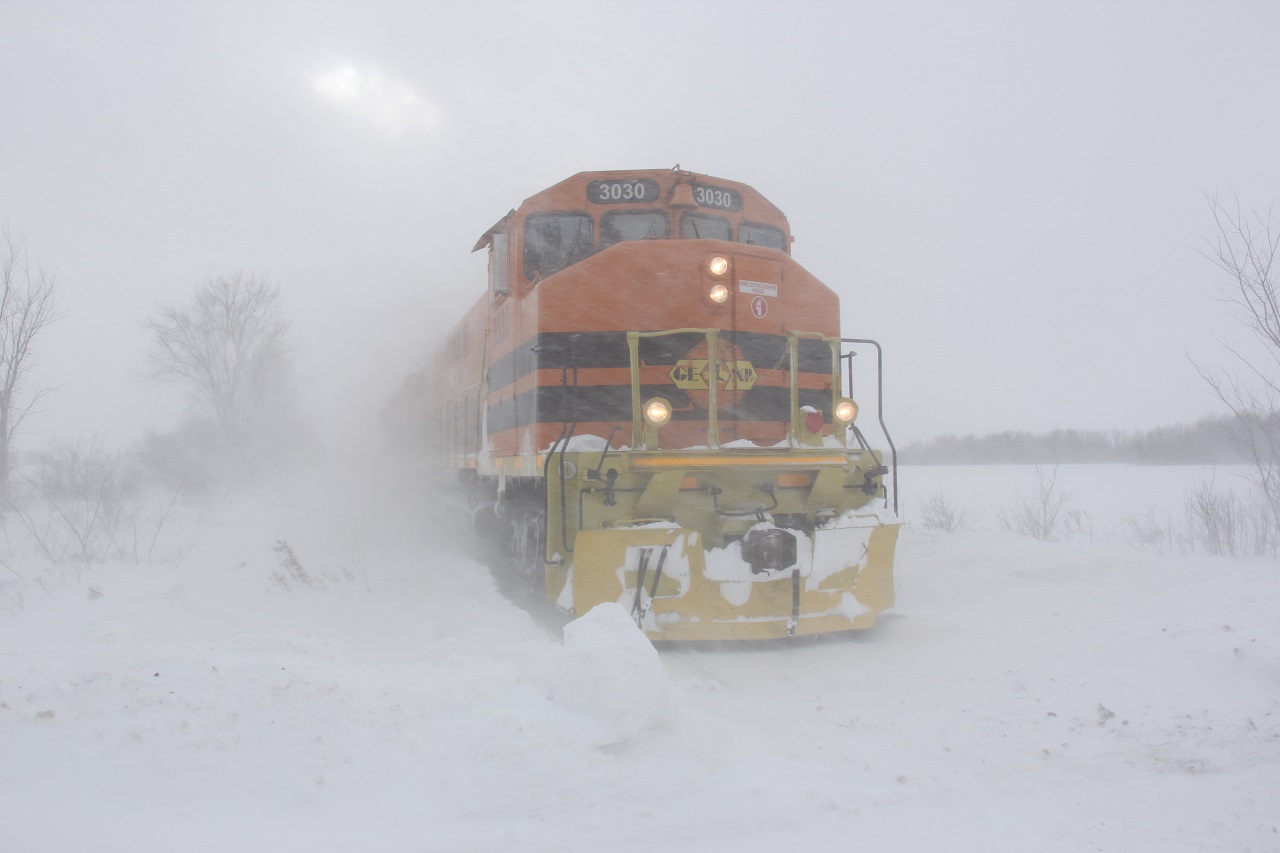 My memory has dodged me on this one (sorry Steve!), but this was taken somewhere in Huron County between Exeter and Clinton on the GEXR Exeter Sub in December last year. The snowsqualls were dauntless, as mother nature is, and with the snow, cold and wind, you can barely see the end of this two locomotive train! Happy New Year to you all and may winter 2018 be as snowy and cold as this image portrays for all of us Canadian Railfanners!