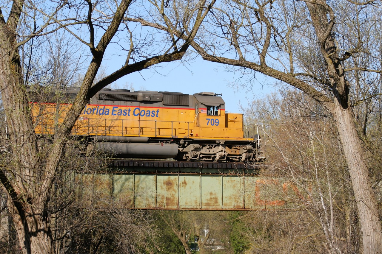 Borrowed Florida East Coast Railroad SD40-2 709 leads Goderich-Exeter Railway train 581 from Goderich through Stratford, Ontario on a spring evening with trailing GSCX SD40-2 7362. The train is headed for the yard in Stratford with engineer Sills at the throttle.