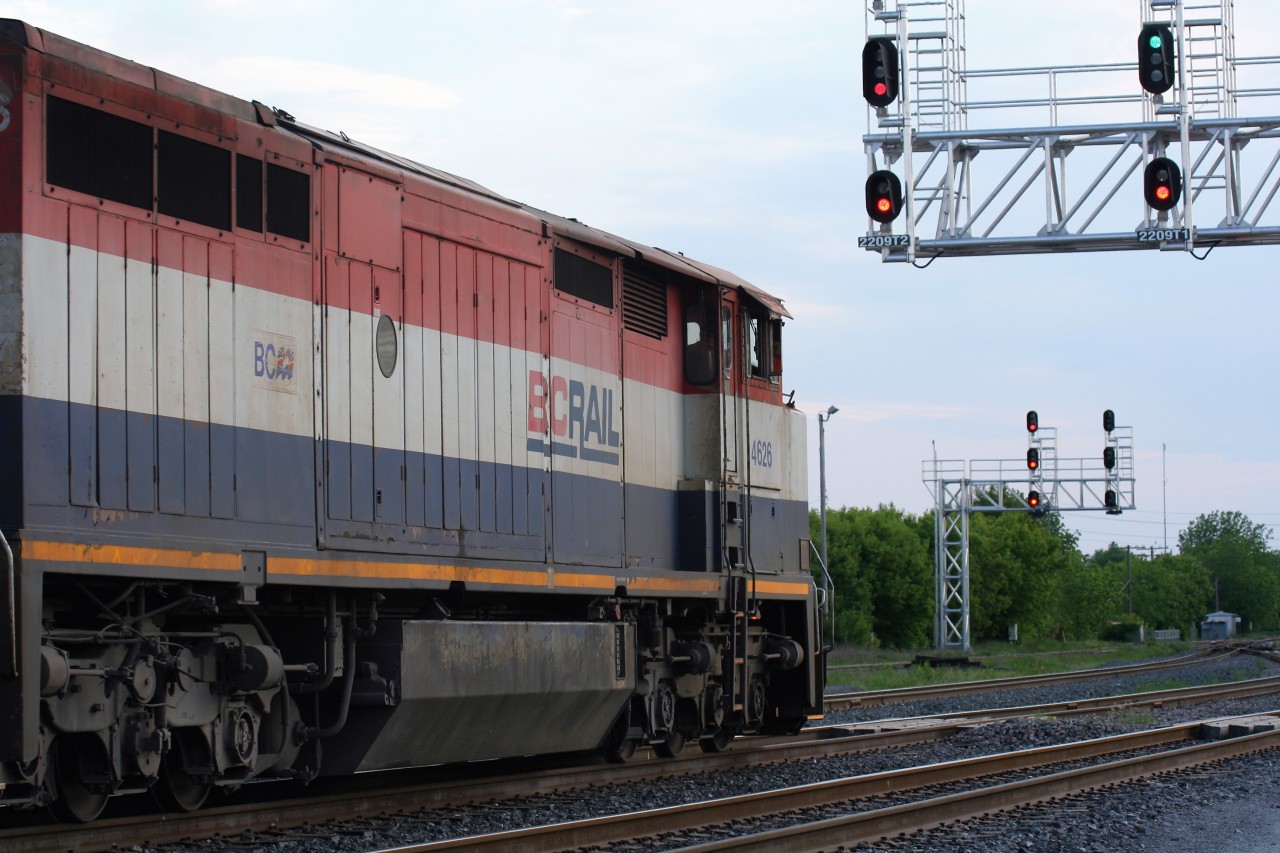 A westbound CN general merchandise train with BCOL Dash 8-40CM 4626 and CN SD75I 5773 gets the green light to depart the yard at Belleville, Ontario on a warm May evening.