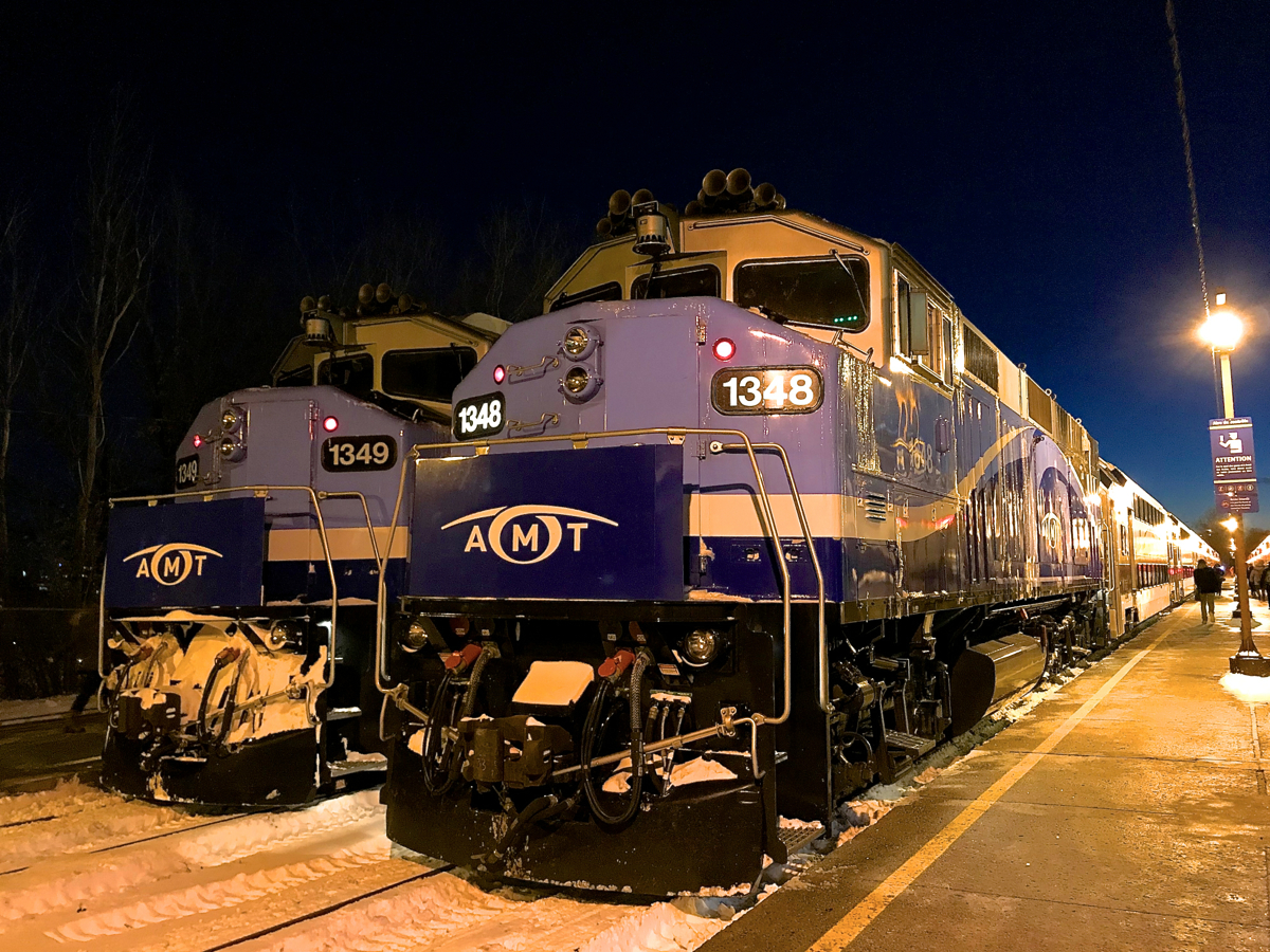 AMT 1348 and AMT 1349 both have their marker lights lit as they await the call to push commuter trains out of downtown Montreal on a frigid evening.