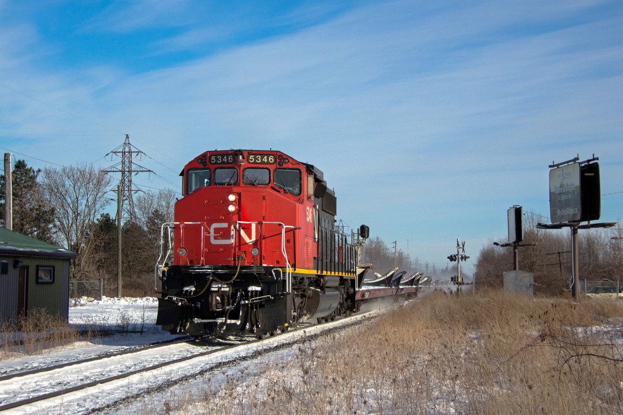 I was honestly dreading this would become a railfan paparazzi shoot, but alas it has. Lol. Though I couldn't be left out. I was aware CN 5346 had come on CN 421 on Christmas Eve day. So I kept an eye on CN during the morning to see if perhaps 5346 would be shuffled about to lead 422, being it was the only widecab available. This did not happen, and all the units except the SD40 from 421 headed back to TO with a stubby train in tow, which may have even been 524. If it was, 422 most likely did not run today. It's scary to think I've railfanned without a scanner for two years... I definitely need to invest in one again.

Nonetheless, the first try was unsuccessful so I monitored ATCS for a while wondering if perhaps CN 5346 had snuck through during the night somehow. And around 1pm a train was lined straight to Hamilton, myself having no clue what train it was since I don't have a working scanner. Sure enough, luck prevailed and CN 5346 was leading, an empty windmill train of all things. Past occurrences have seen these windmill flats tacked on the end of 422 or 524, rather than a dedicated 315. Today was different, perhaps having to do with the fact it was the day after Christmas. An independent widecab SD40-2W does look pretty iconic on a train, even if it is just flats. Only around 30 of these were in tow, so this was an easy job for this old soldier. L315 would take the cowpath to the Dundas Sub afterwards, heading back into the midwest states presumably for more windmill blades. I'll take this as a late Christmas gift, and am especially thankful it came in the afternoon, yielding a rare case a CN Niagara westbound freight is sunlit.

I chose Beamsville as the location having no idea what type of lashup to expect. It definitely appears it worked out. Beamsville is one of the more nostalgic locations for me in terms of railfanning, as it goes back for me well over a decade. I've avoided it for most part for about six years since it's a good place to draw unwanted attention from the public unfortunately. Being in the a very flat straight section, CN trains (westbounds mostly) regularly get up to 50-60mph here, which is not as easy to find in Niagara as some may think. Passenger trains still trundle along at 65mph here, though that potentially could change once Metrolinx finally gets permanent GO train service to Niagara Falls. 

It's interesting to note I said two years ago when I saw CN 5274 lead CN 330 that perhaps that would be the last time an SD40 is seen leading a train in Niagara. With the economy downturning, it sure looked like that statement may hold. The surge in traffic on CN recently has proved otherwise however. As our moderator had mentioned, this very well could be the last stand for strong variety on CN with the company being quite power short. Class 1's in general are quickly losing that common variety aspect. Once CN's massive order of two hundred AC GEVOs arrive, a lot of coffins will be nailed. SD40s evidently have specific advantages their higher horsepower successors lack though, as many class 1's are still avid users of them for lighter train duties despite their age. So perhaps these will once again slip past the next chopping block while their closer in age successors fade away. Though, maybe not. Regardless, there's a long stood era that's coming to an end, which is the expectation that one will be kept in suspense with variety on class 1 freight roads. One can argue that era is already over, though for what remains of it, make the most of this time before it is almost unanimously agreed upon.