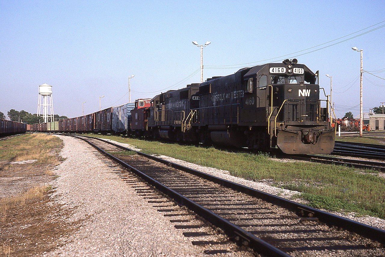 N&W 4160 and 4161 pause at the CN office for paperwork at the Fort Erie yard, before proceeding westward. Unfortunately I did not record the caboose behind the power. Note the adjacent car is an "I Love NY" promotion paint scheme that was rather popular along the D&H back then. The two GPs shown were part of a small set on the N&W roster (4160-4163) that were in service on the NW/NS from 1982 to 1992.