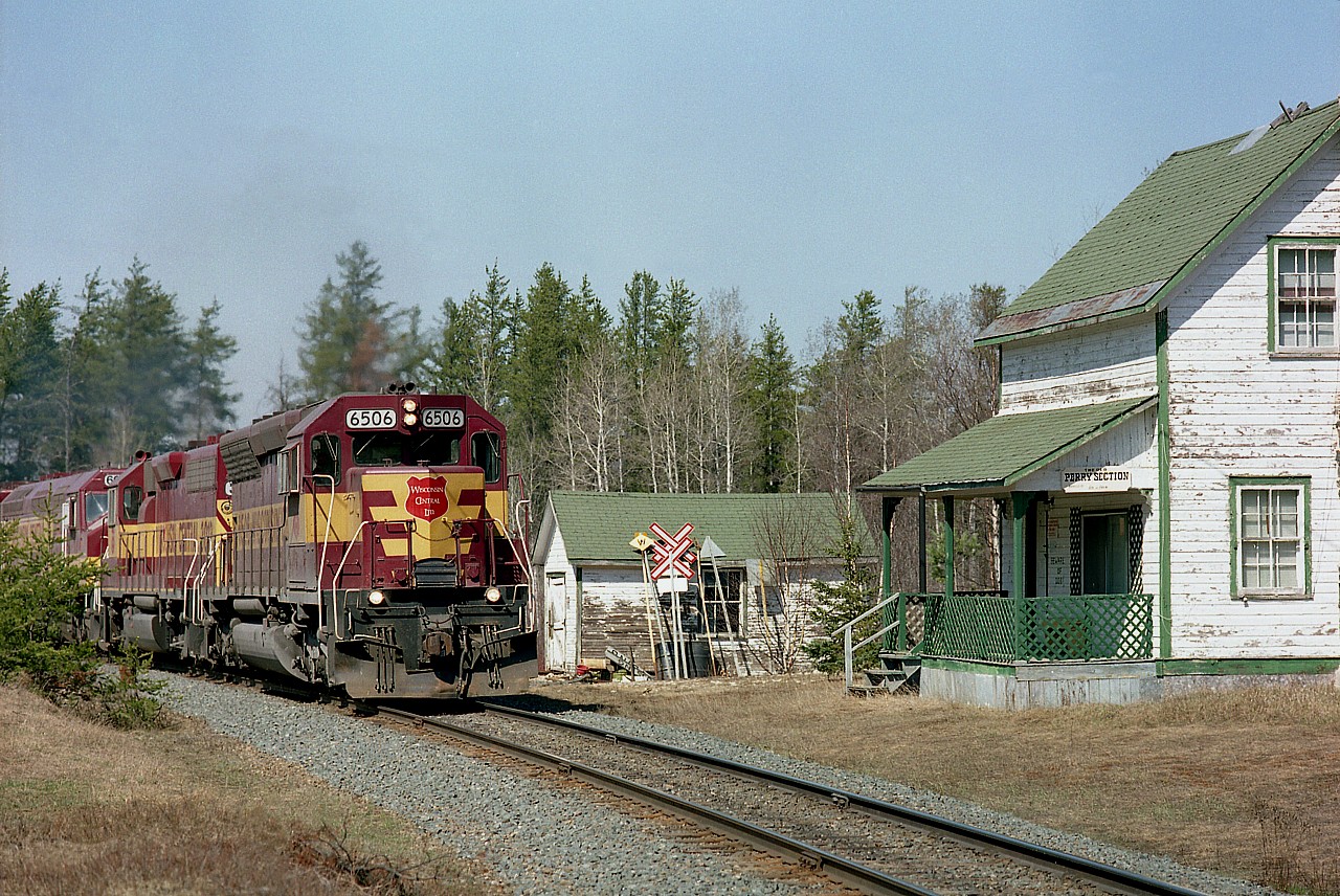 WC 6506, 3012, 6655 and 6004 are rounding a slight curve passing the old Perry Sectionhouse (mile 149.9)on their way South to Sault Ste. Marie from the Sinter Plant near Wawa on the now gone Michipicoten Sub. This was the first of three southbounds seen over the day, and unfortunately I was not able to get the train number. The SectionHouse is in dire need of a coat of paint, but that is really about it.  I understand it survives still, probably a privately owned building like so many of those along the rather remote former Algoma Central line.
