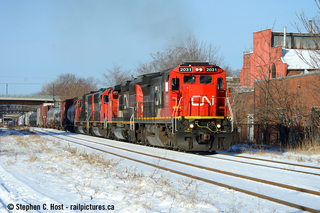 As Snake would say.. Steel Steve returns  If this is the last train on CN I photograph in 2017 I'm good. I had no plans to go out, but with the sun full blast I got my butt out to get some Vitamin D, and a timely heads up about this movement from a Hamilton friend: CN 421 just finished work @ Hamilton Yard and is blasting off with an amazing lashup: CN 2034 (Dash 8), CN 5346 (SD40-2), CN 5471 (SD60), CN 5442 (SD60). With 200 more GEVO's coming, and the new lease fleet on the property (and still coming) - this will be the last good winter for CN - get it while you can folks. This time next year the GEVO invasion should be in full swing and CN will probably be a heck of a lot like CP in the motive power variety department. Just about everything in this lashup will likely be replaced by the GEVO invasion, unless by some miracle CN's busier than ever and can't get rid of their second hand fleet let alone the greasy ugly leasers starting to show around here. One thing is certain,  Winter 2018 is going to be worth your time on CN.
Merry Christmas everyone!